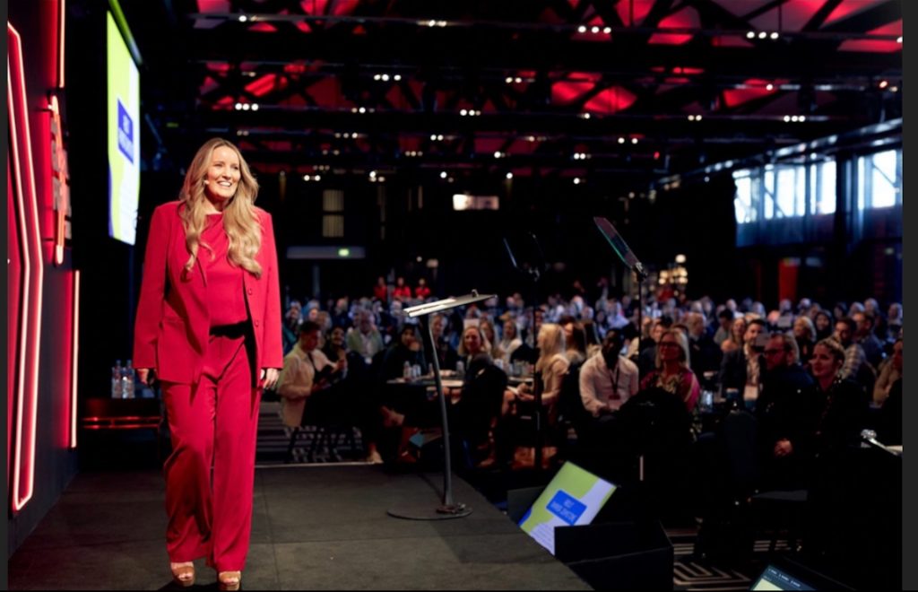 Amanda Johnstone speaking on stage at a conference