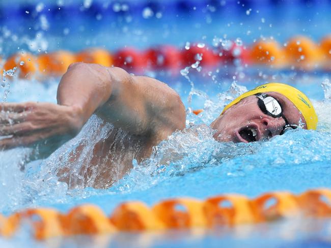 Kieren Perkins racing in the pool wearing an Australian swim cap