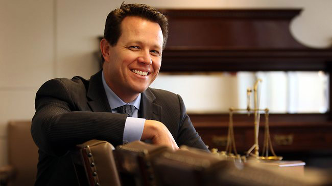 Kieren Perkins smiling in a formal setting