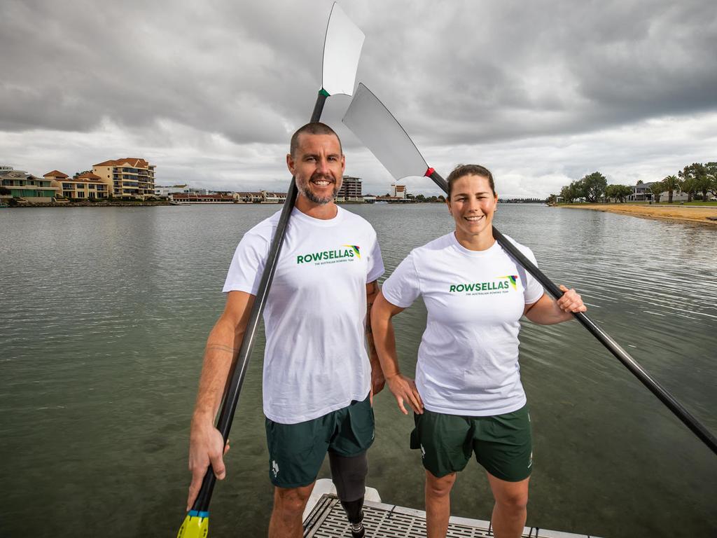 Jed Altschwager and a fellow Rowsellas teammate holding oars