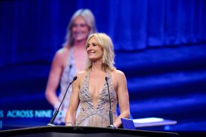 Anneke Van Den Broek accepting award on stage