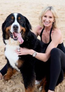 Anneke Van Den Broek with dog on beach