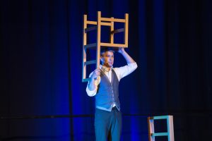 Dan Aubin balancing a chair on his head