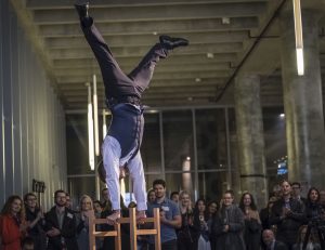 Dan Aubin performing a handstand on stacked chairs