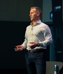 Ant Williams presenting on stage