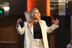 Kellie Tomney presenting on stage
